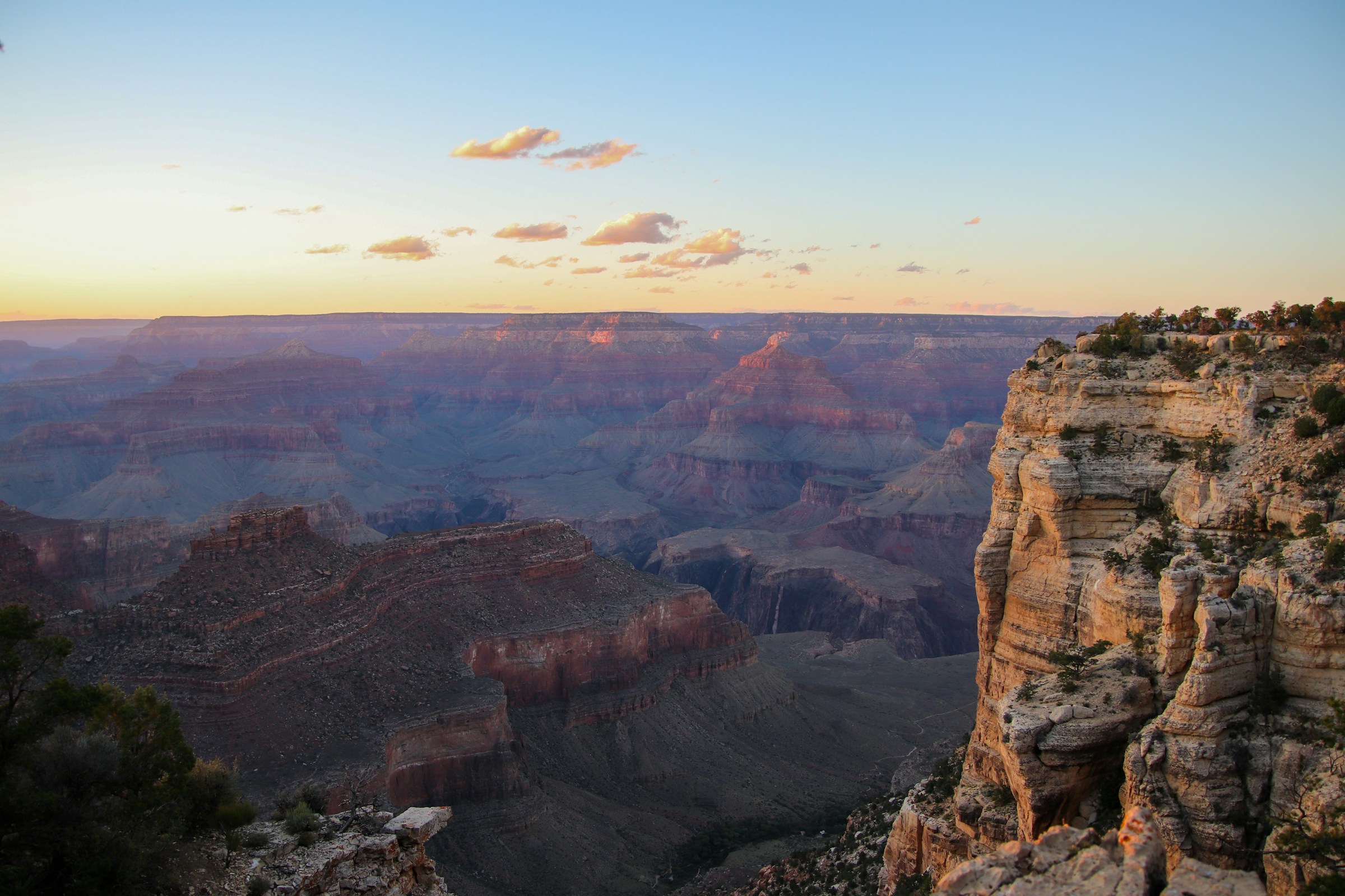 Canyon walls glowing at sunset from the rim