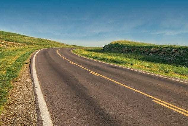 Highway winding through Flint Hills prairie